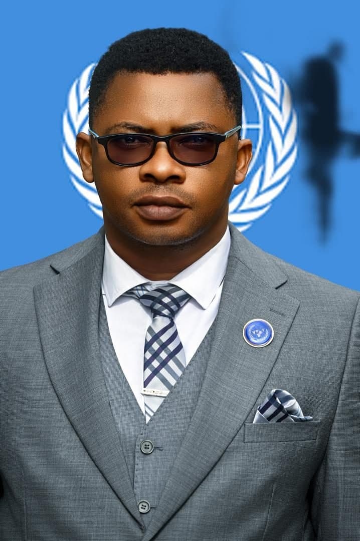 Ambassador Professor Joseph Legend Mfon photographed against a United Nations emblem.